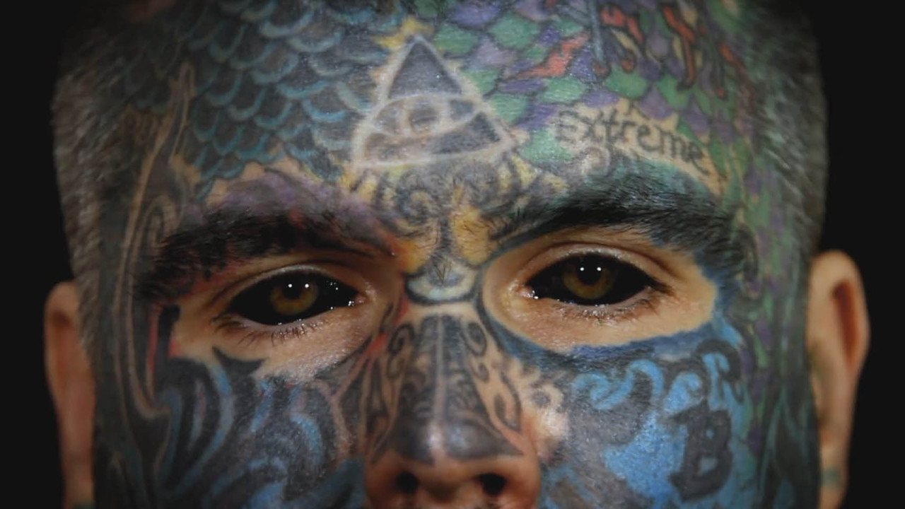 2,000 Tattoos, 40 Piercings, and a Pickled Ear backdrop