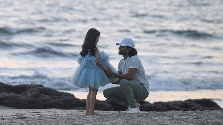 Mahi looking at her father with curiosity
